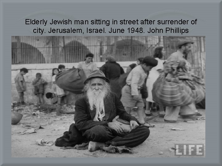 Elderly Jewish man sitting in street after surrender of city. Jerusalem, Israel. June 1948.