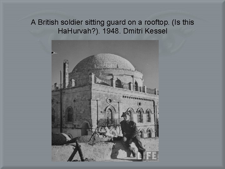 A British soldier sitting guard on a rooftop. (Is this Ha. Hurvah? ). 1948.