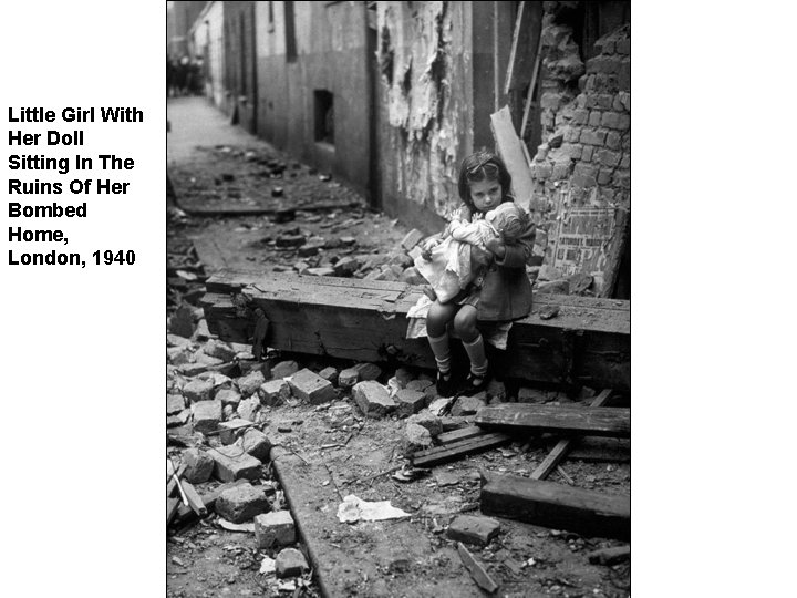 Little Girl With Her Doll Sitting In The Ruins Of Her Bombed Home, London,