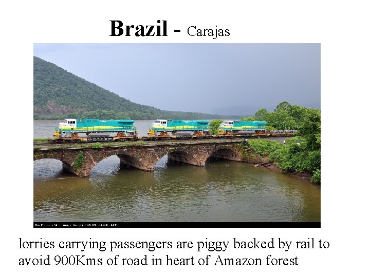 Brazil - Carajas lorries carrying passengers are piggy backed by rail to avoid 900