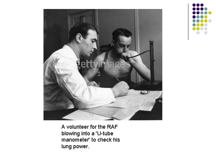A volunteer for the RAF blowing into a 'U-tube manometer' to check his lung