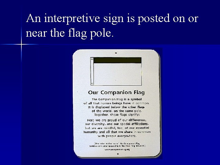 An interpretive sign is posted on or near the flag pole. 