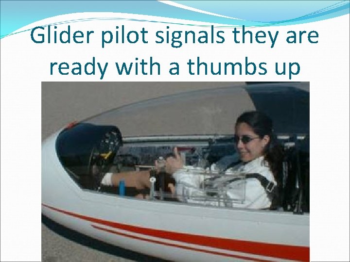 Glider pilot signals they are ready with a thumbs up 