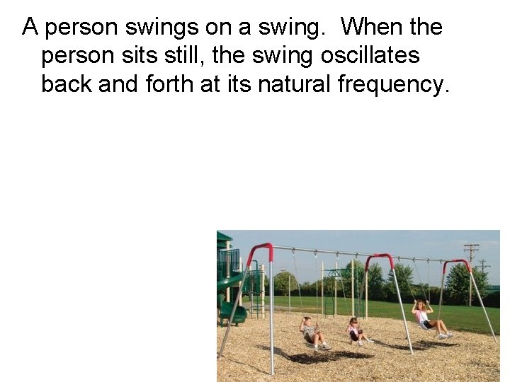 A person swings on a swing. When the person sits still, the swing oscillates