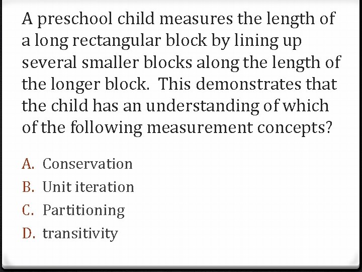 A preschool child measures the length of a long rectangular block by lining up