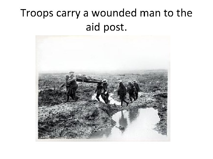 Troops carry a wounded man to the aid post. 