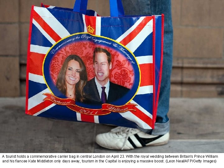 A tourist holds a commemorative carrier bag in central London on April 23. With