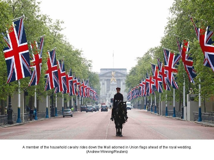 A member of the household cavalry rides down the Mall adorned in Union flags