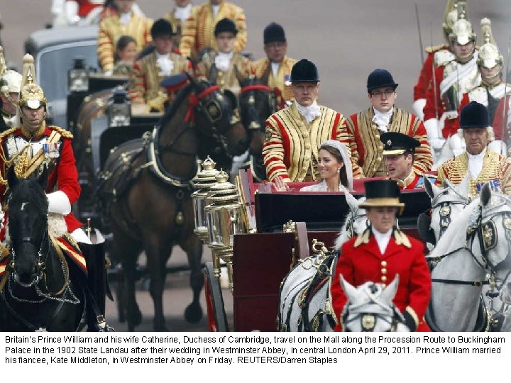 Britain’s Prince William and his wife Catherine, Duchess of Cambridge, travel on the Mall