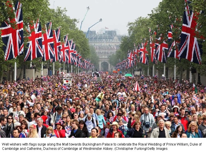 Well wishers with flags surge along the Mall towards Buckingham Palace to celebrate the