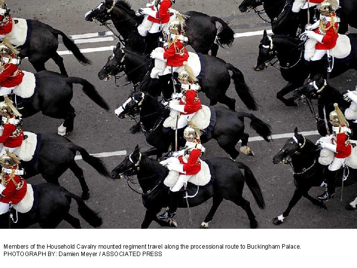 Members of the Household Cavalry mounted regiment travel along the processional route to Buckingham