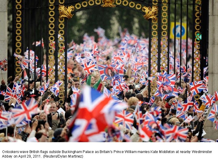 Onlookers wave British flags outside Buckingham Palace as Britain's Prince William marries Kate Middleton