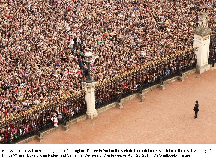 Well wishers crowd outside the gates of Buckingham Palace in front of the Victoria