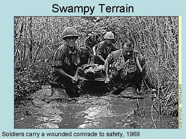 Swampy Terrain Soldiers carry a wounded comrade to safety, 1969 