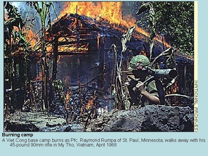 Burning camp A Viet Cong base camp burns as Pfc. Raymond Rumpa of St.