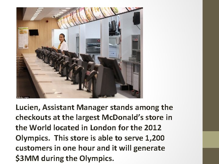 Lucien, Assistant Manager stands among the checkouts at the largest Mc. Donald’s store in