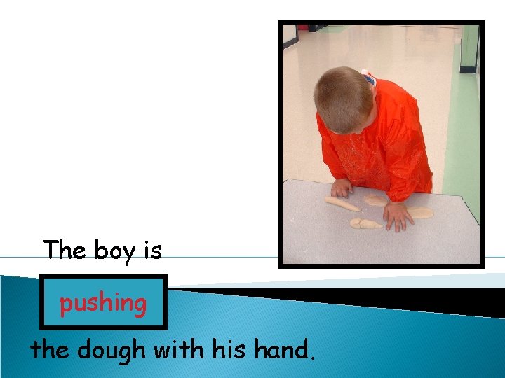 The boy is pushing the dough with his hand. 