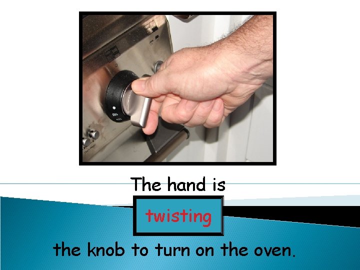 The hand is twisting the knob to turn on the oven. 