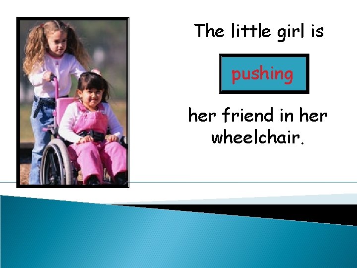 The little girl is pushing her friend in her wheelchair. 