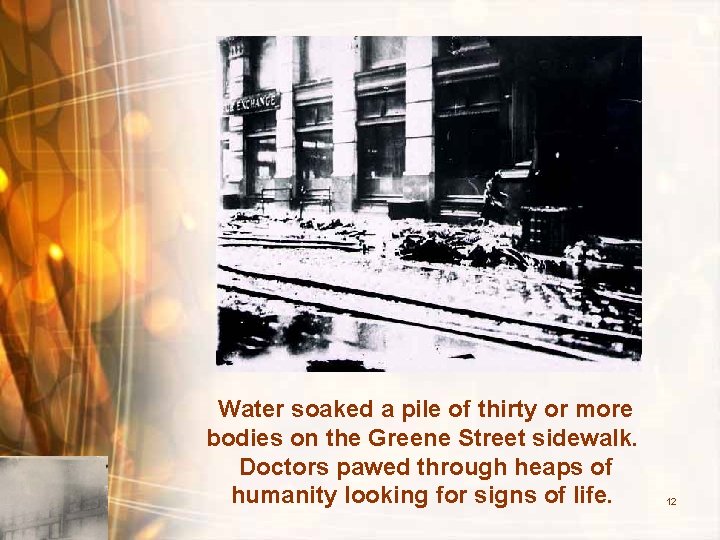 Water soaked a pile of thirty or more bodies on the Greene Street sidewalk.