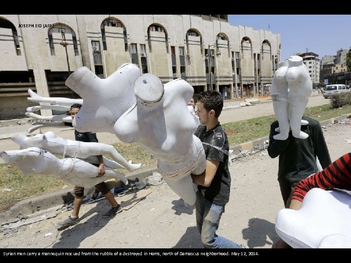 JOSEPH EID (AFP) Syrian men carry a mannequin rescued from the rubble of a