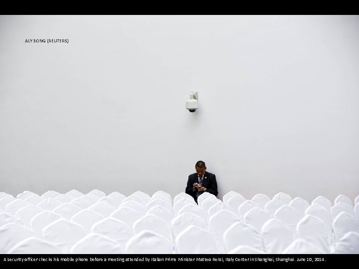 ALY SONG (REUTERS) A security officer checks his mobile phone before a meeting attended