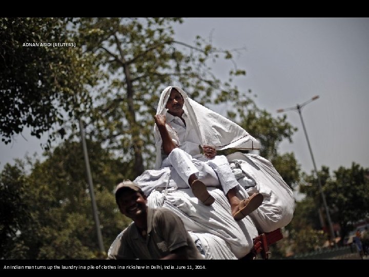 ADNAN ABIDI (REUTERS) An Indian man turns up the laundry in a pile of