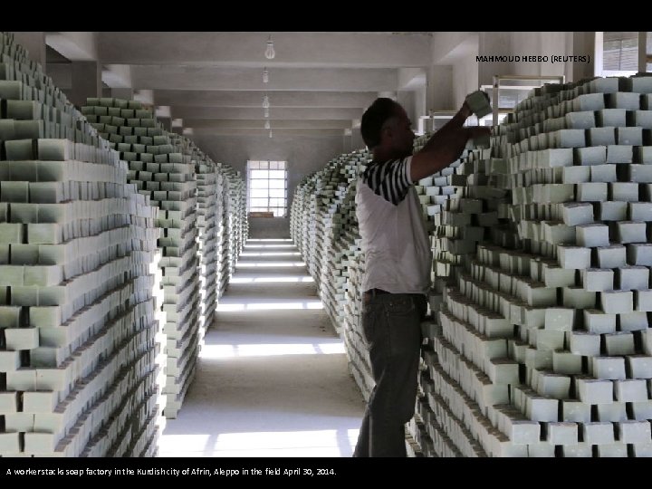 MAHMOUD HEBBO (REUTERS) A worker stacks soap factory in the Kurdish city of Afrin,