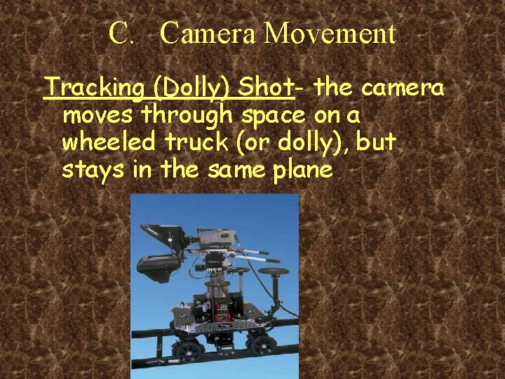 C. Camera Movement Tracking (Dolly) Shot- the camera moves through space on a wheeled