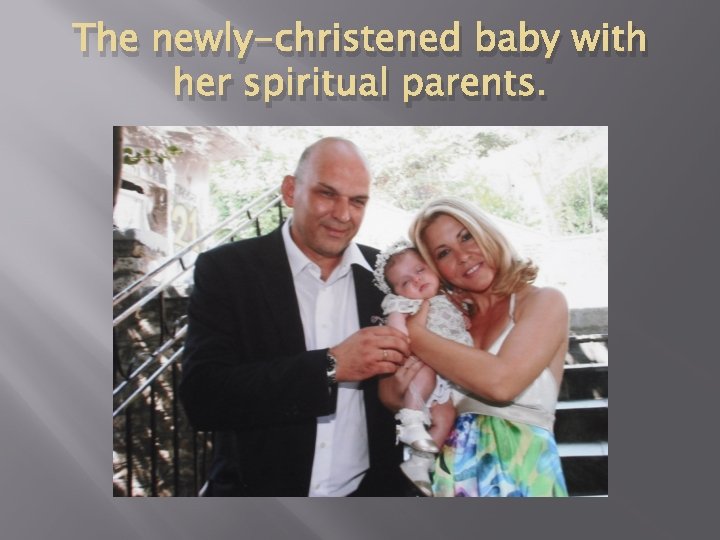 The newly-christened baby with her spiritual parents. 