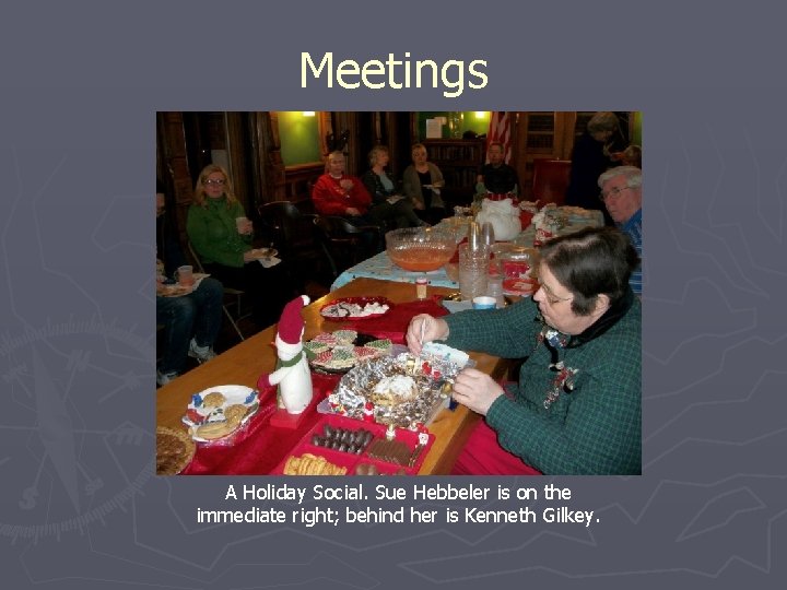 Meetings A Holiday Social. Sue Hebbeler is on the immediate right; behind her is