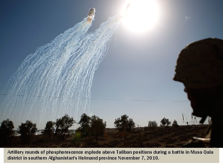 Artillery rounds of phosphorescence explode above Taliban positions during a battle in Musa Qala
