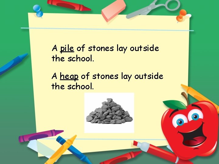 A pile of stones lay outside the school. A heap of stones lay outside