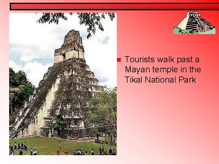 n Tourists walk past a Mayan temple in the Tikal National Park n Tourists walk past a Mayan temple in the Tikal National Park