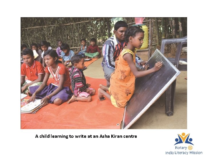 A child learning to write at an Asha Kiran centre 