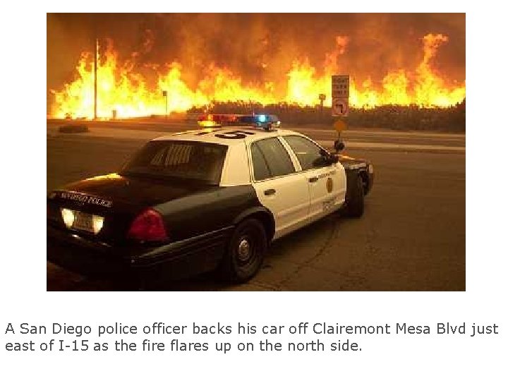 A San Diego police officer backs his car off Clairemont Mesa Blvd just east