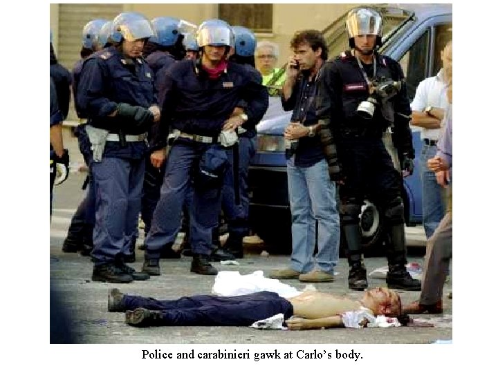 Police and carabinieri gawk at Carlo’s body. 