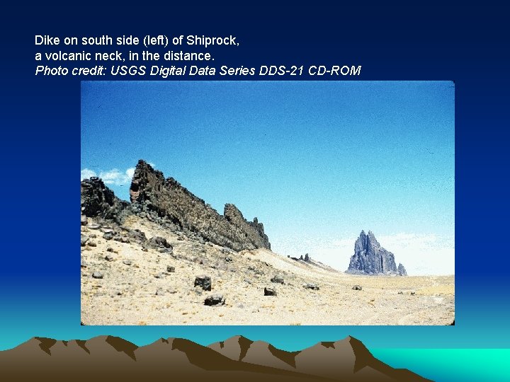 Dike on south side (left) of Shiprock, a volcanic neck, in the distance. Photo