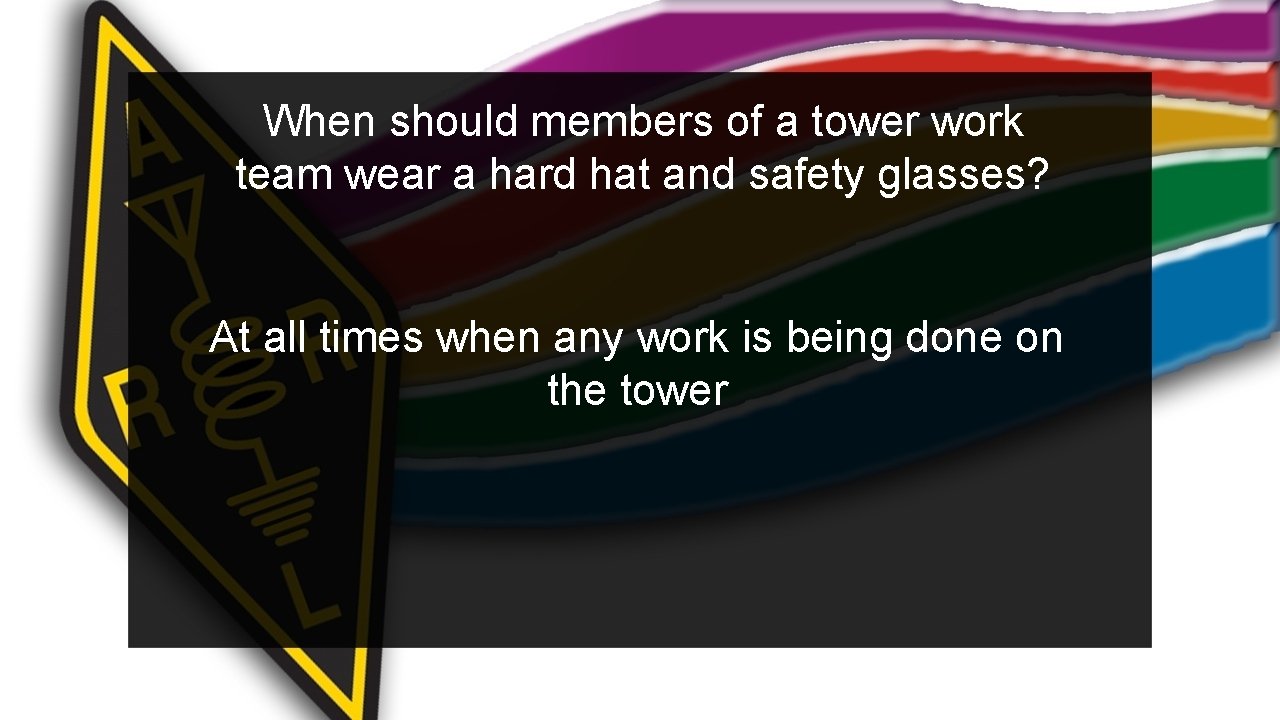 When should members of a tower work team wear a hard hat and safety