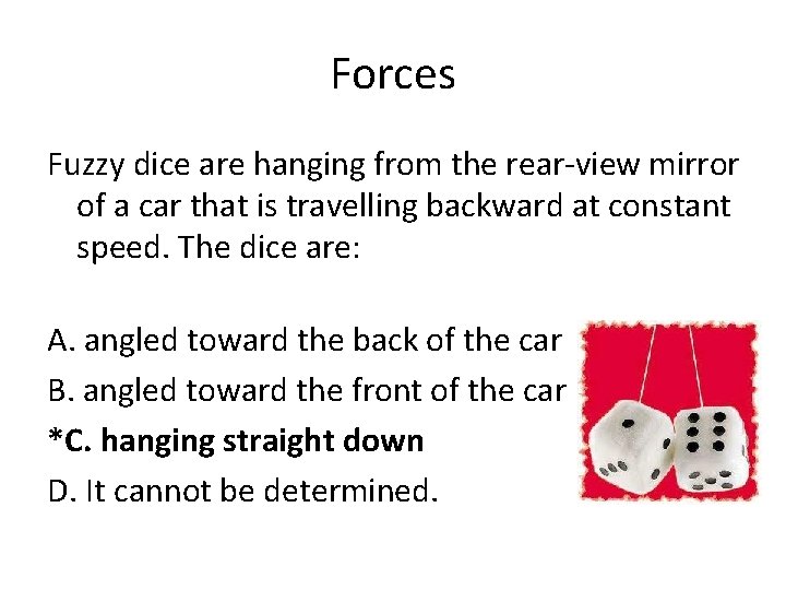 Forces Fuzzy dice are hanging from the rear-view mirror of a car that is