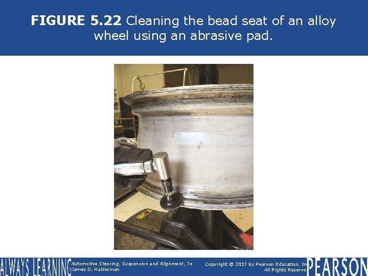 FIGURE 5. 22 Cleaning the bead seat of an alloy wheel using an abrasive