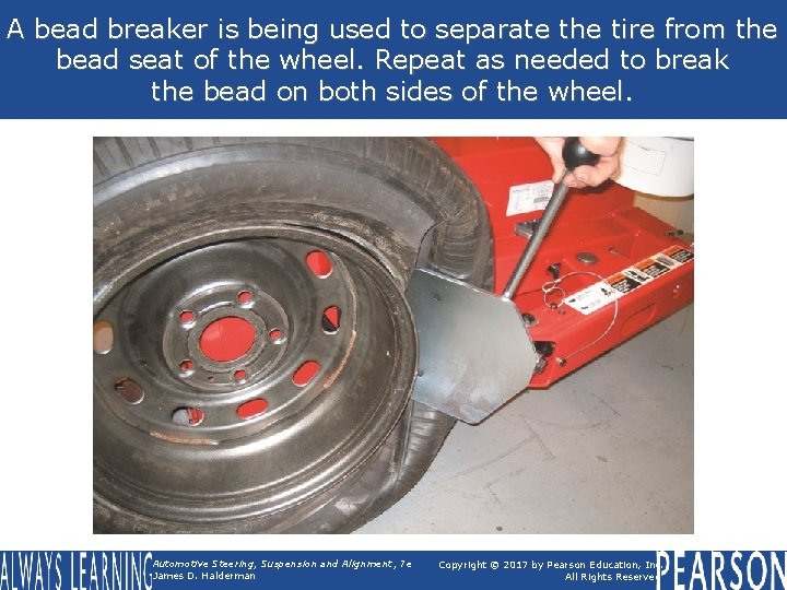 A bead breaker is being used to separate the tire from the bead seat