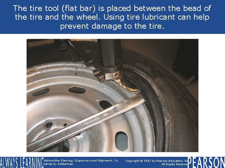 The tire tool (flat bar) is placed between the bead of the tire and