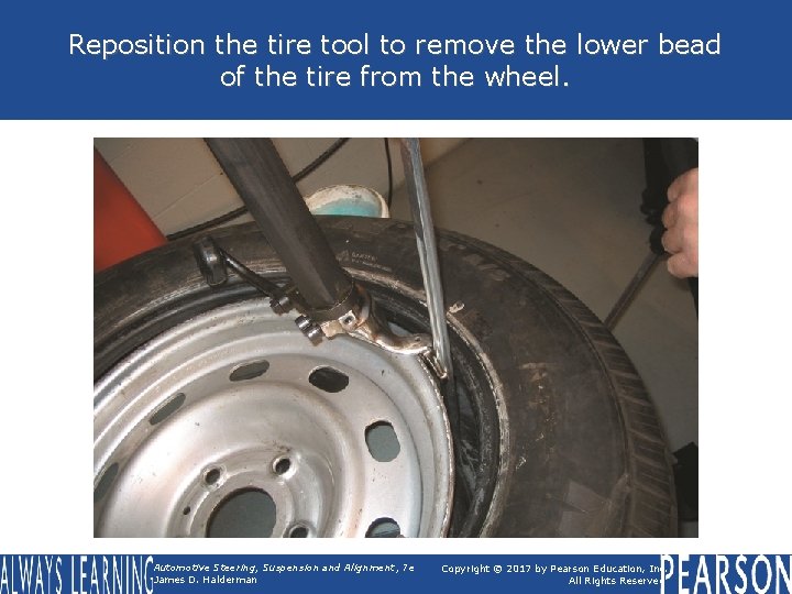 Reposition the tire tool to remove the lower bead of the tire from the