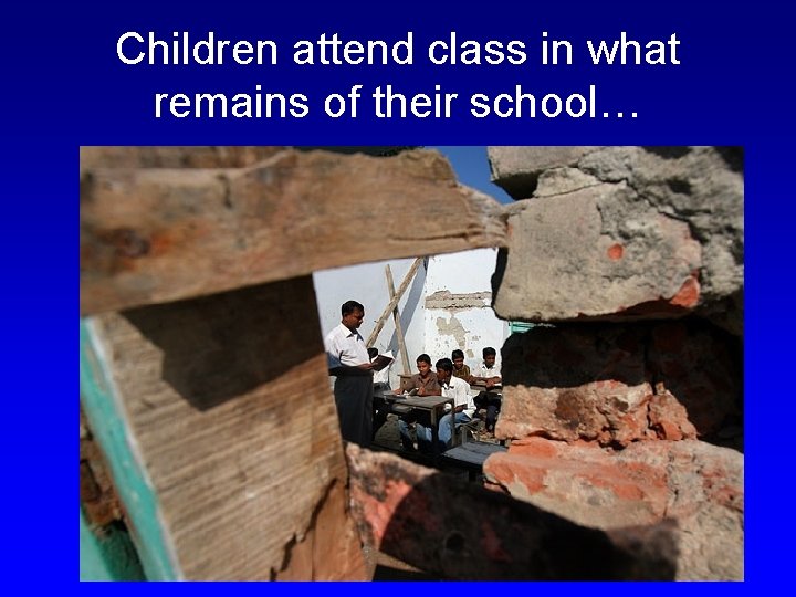 Children attend class in what remains of their school… 