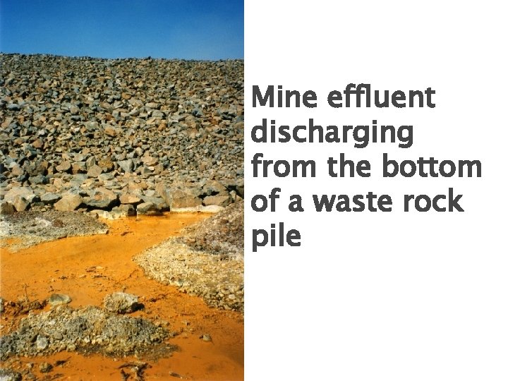 Mine effluent discharging from the bottom of a waste rock pile 