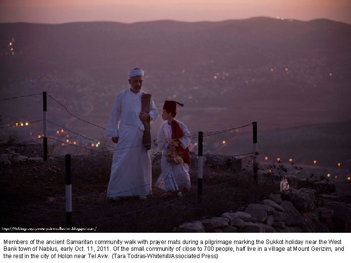 Members of the ancient Samaritan community walk with prayer mats during a pilgrimage marking