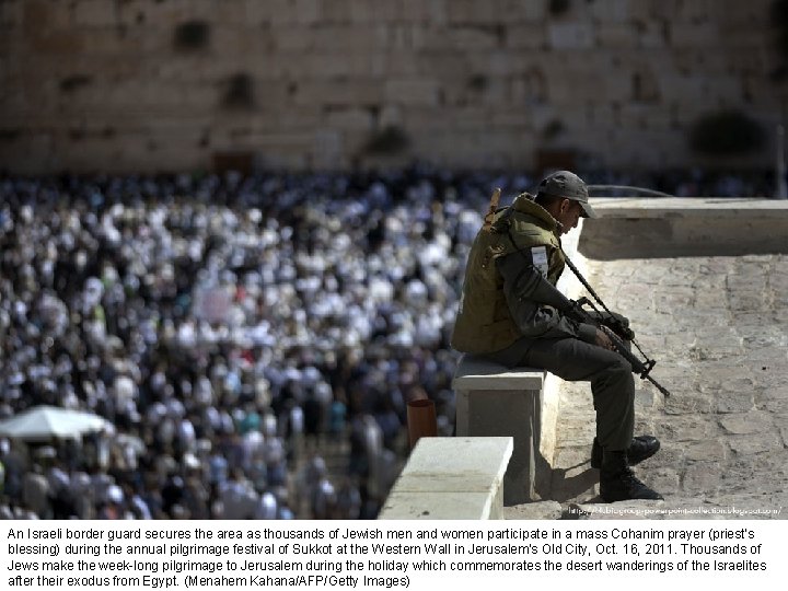 An Israeli border guard secures the area as thousands of Jewish men and women