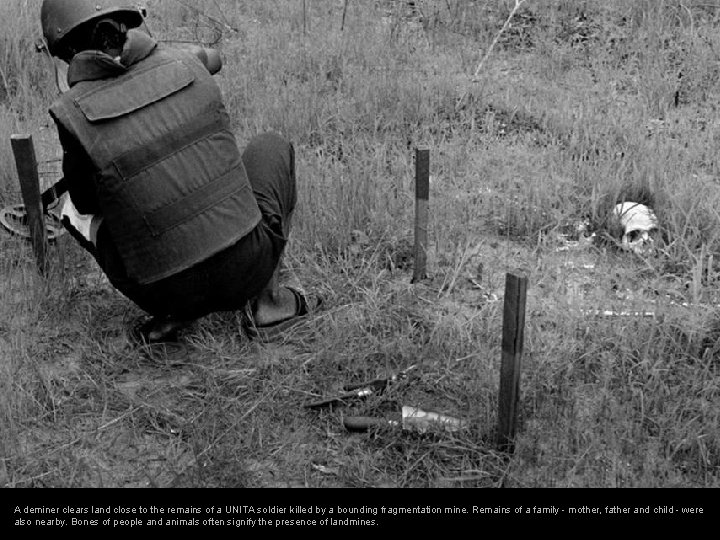 A deminer clears land close to the remains of a UNITA soldier killed by A deminer clears land close to the remains of a UNITA soldier killed by