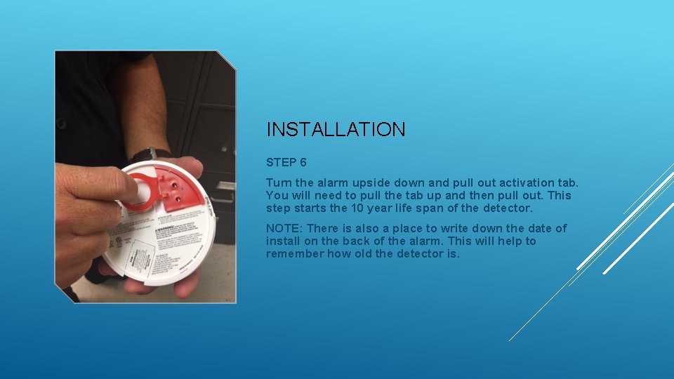 INSTALLATION STEP 6 Turn the alarm upside down and pull out activation tab. You